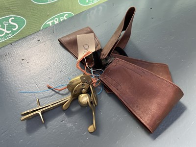 Lot 240 - Brass shaft fittings together with a pair of brass catches and four brown leather covers