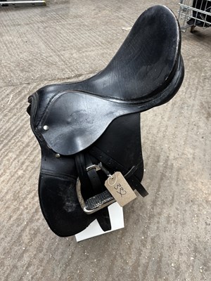 Lot 332 - 17.5" black leather saddle with stirrup leathers and irons