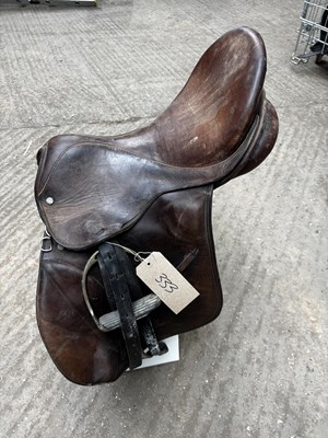 Lot 333 - 18" brown leather saddle by G E Jeffries with stirrup leathers and irons