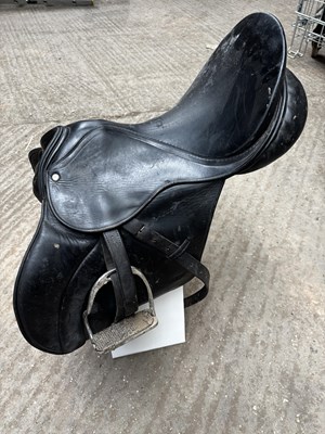 Lot 334 - 18" black leather saddle with stirrup leathers and irons