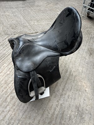 Lot 335 - 18" black leather saddle with stirrup leathers and irons
