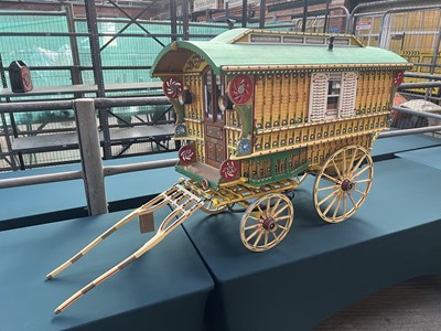 Lot 553 - Large model gypsy caravan with removable roof, painted yellow and green, complete with lamps and shafts. 148 x 90cm (including wheels and shafts)
