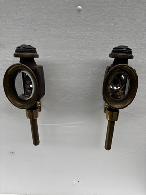 Lot 877 - Pair of black and brass oval fronted carriage lamps