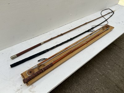 Lot 887 - Two old holly whips, together with a jointed whip on a board