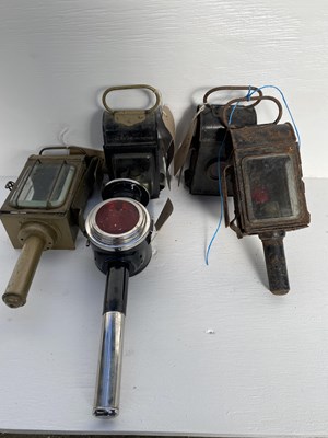 Lot 896 - Brass candle lamp with side bracket; one black candle lamp; two 'Raydyot' black painted paraffin lanterns; and a black and white metal rear lamp