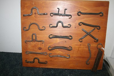 Lot 1007 - Display board of antique heavy horse bits
