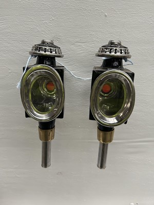 Lot 1061 - Pair of black and white metal oval fronted lamps. This lot carries VAT.