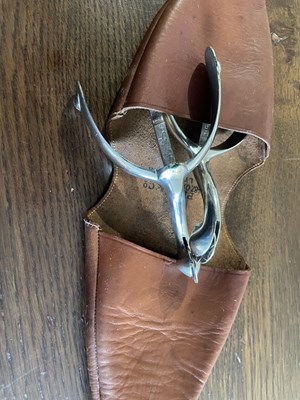 Lot 1080 - Peal & Co. leather pouch containing a pair of Cavalry spurs