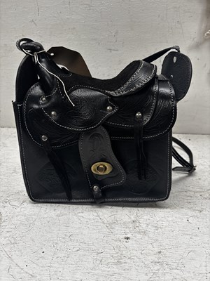 Lot 1083 - Black leather bag with Western saddle