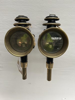 Lot 1089 - Pair of black and brass round fronted lamps with curved sides