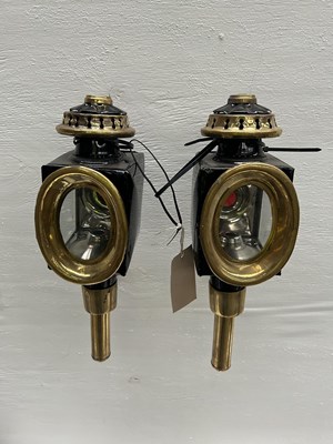Lot 1128 - Pair of black and brass oval fronted lamps. This lot carries VAT.