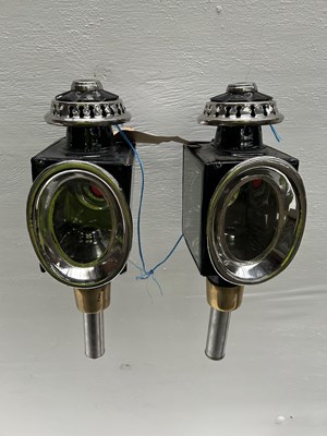 Lot 1155 - Pair of black and white metal oval fronted lamps. This lot carries VAT.