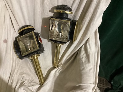 Lot 1165 - Pair of oval black and brass Lawton lamps