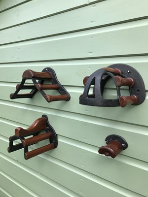 Lot 1208 - Musgrave of Belfast cast iron and mahogany harness racks