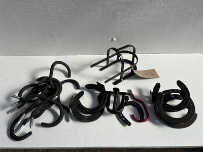 Lot 1254 - Metal stand, metal racking, ten harness hooks, bridle hanger, six horseshoe hangers and two other items
