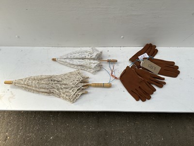 Lot 1287 - Two pairs of new driving gloves with two lace parasols