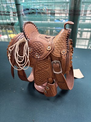 Lot 632 - Miniature western saddle on wooden stand