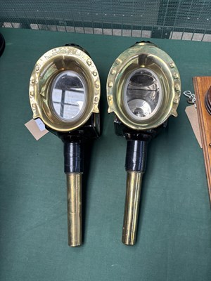 Lot 817 - Pair of black and brass horseshoe fronted lamps. This lot carries VAT.