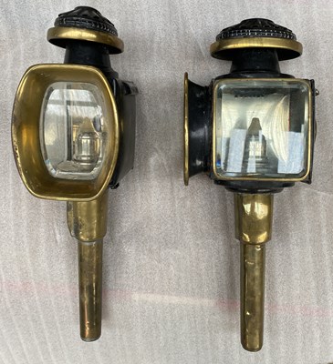 Lot 824 - Pair of black and brass gig lamps by Lawton of London. 45cm.
