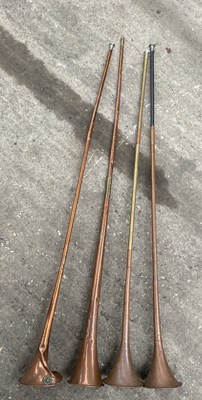 Lot 826 - Four copper coach horns, length crca 120cm