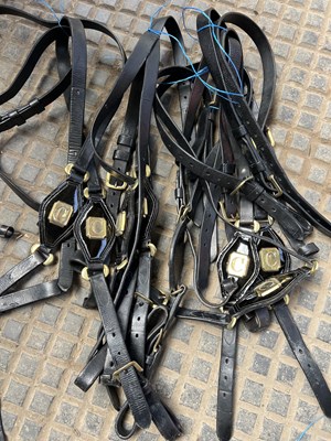 Lot 858 - Pair sets of black leather trace carriers with patent decorative emblem with 'C' and one strap